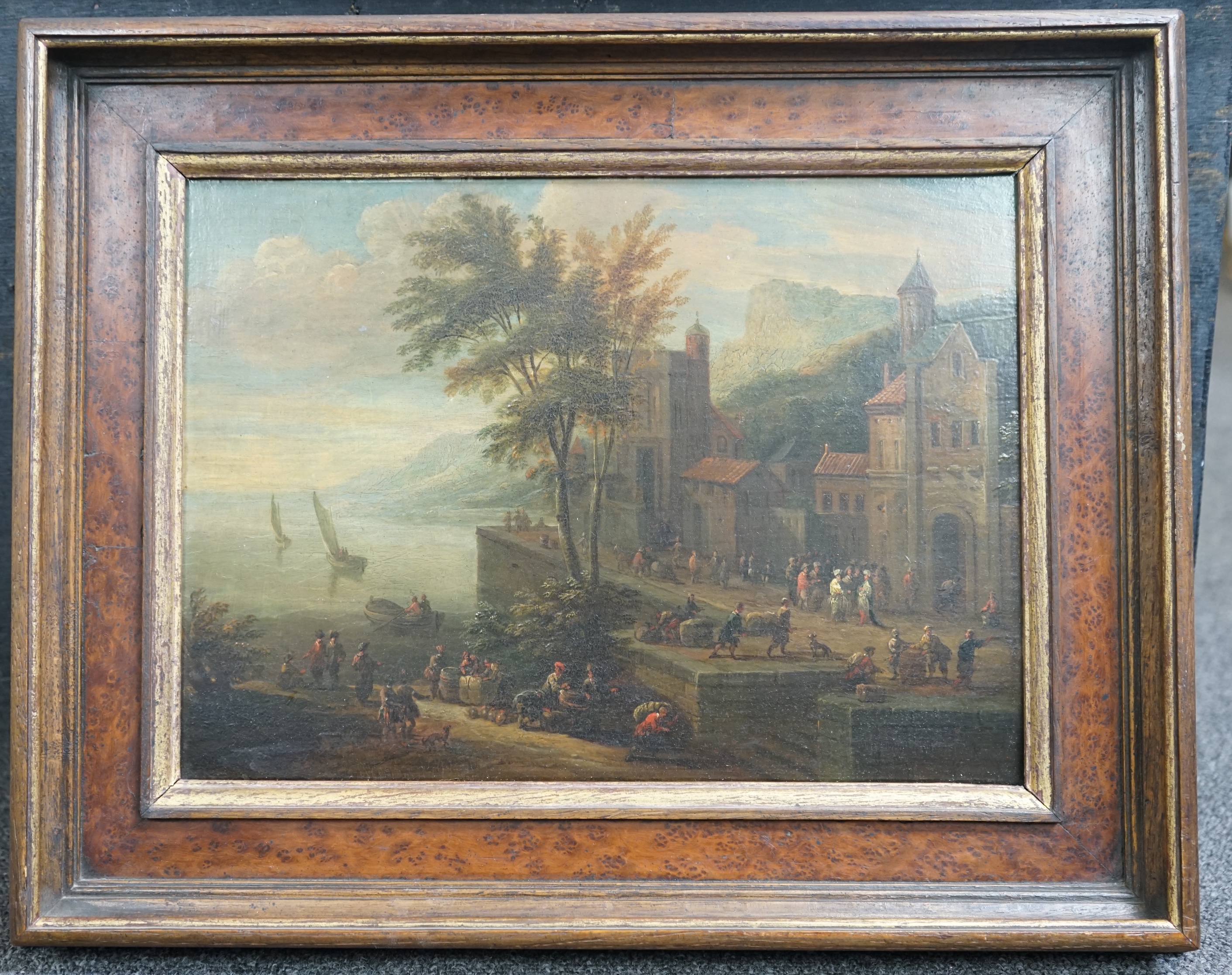 Pieter Bout (Brussels 1658-1702) and Adriaen Frans Boudewijns (Brussels 1644-1711), A coastal port with figures moving cargo and, A fortified town with revellers beyond the walls, oil on panel, a pair, 23 x 32cm